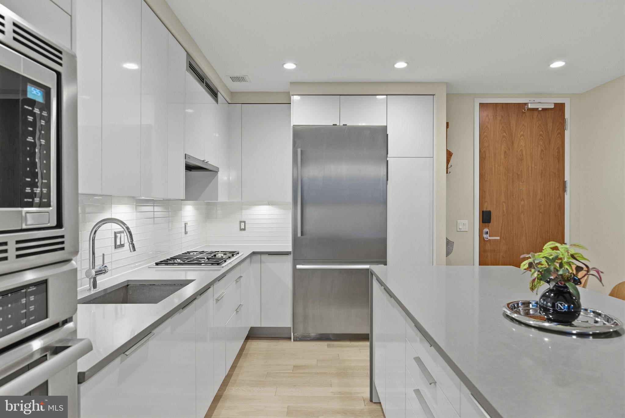 45 Sutton Square Southwest, Unit 403 Washington, DC 20024 - Photo 14 of 80 a kitchen with granite countertop a refrigerator and a sink