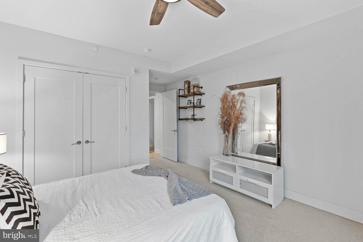 45 Sutton Square Southwest, Unit 403 Washington, DC 20024 - Photo 17 of 80 a bedroom with a bed and a chandelier