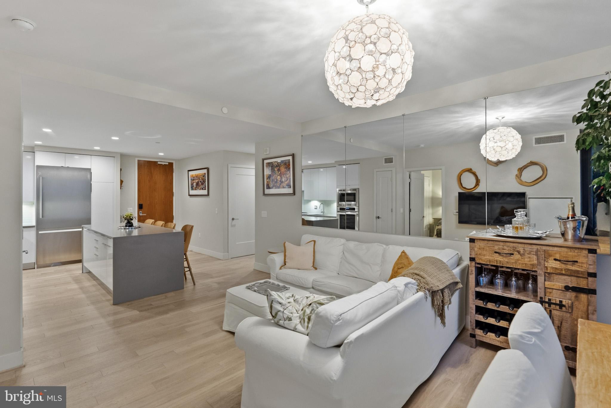 45 Sutton Square Southwest, Unit 403 Washington, DC 20024 - Photo 18 of 80 a living room with furniture kitchen view and a large window