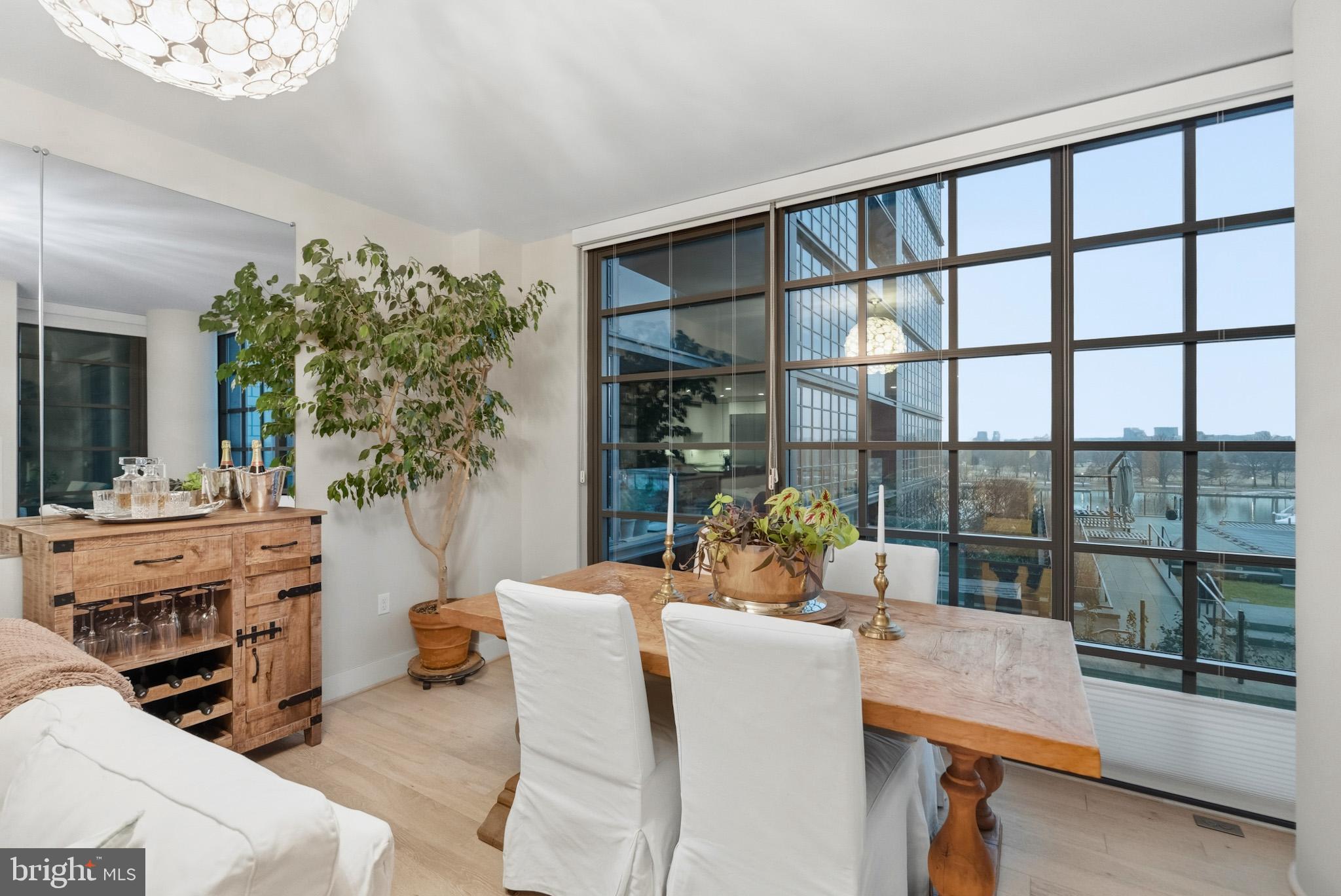 45 Sutton Square Southwest, Unit 403 Washington, DC 20024 - Photo 22 of 80 a living room with furniture and a floor to ceiling window