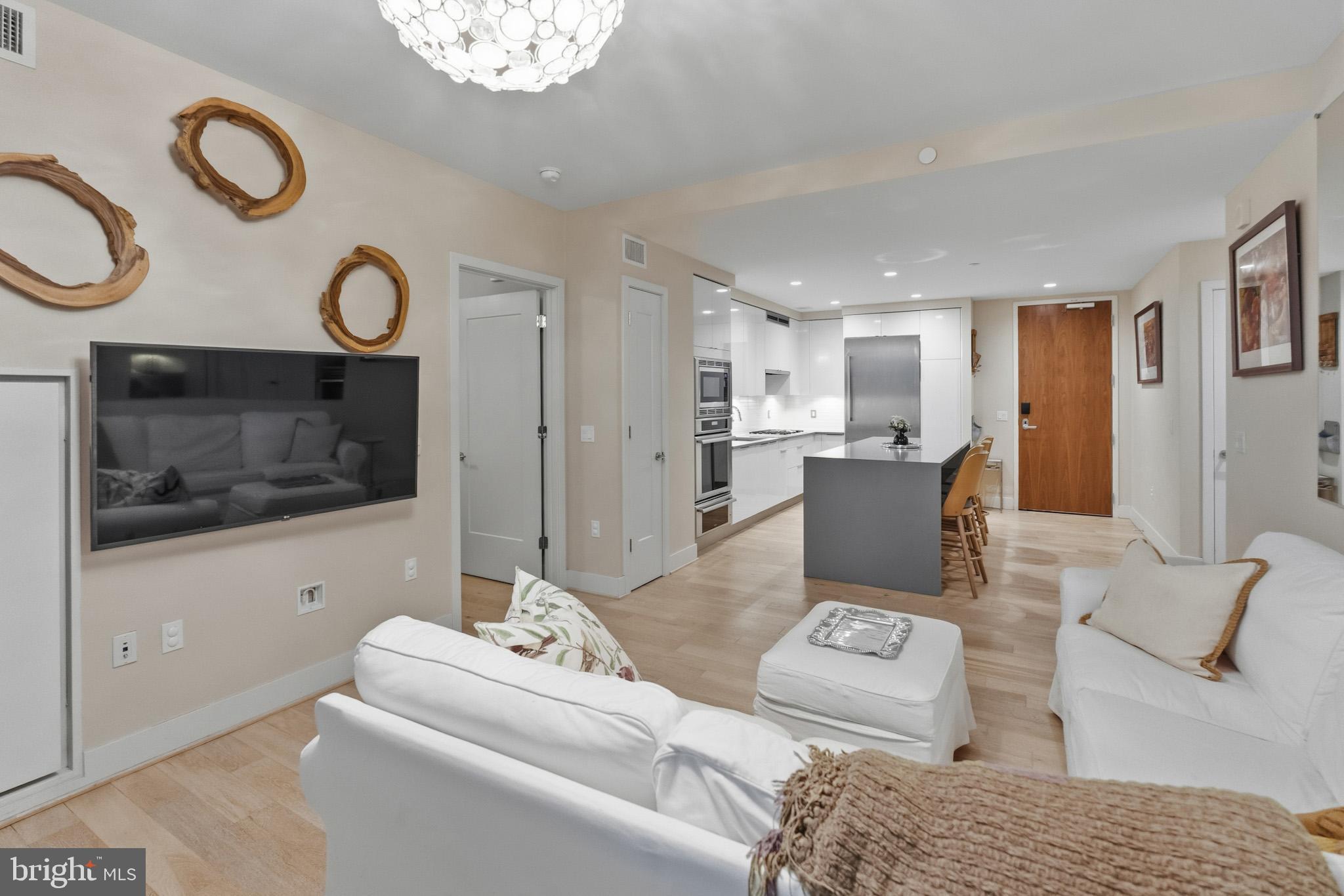 45 Sutton Square Southwest, Unit 403 Washington, DC 20024 - Photo 24 of 80 a living room with furniture and a flat screen tv