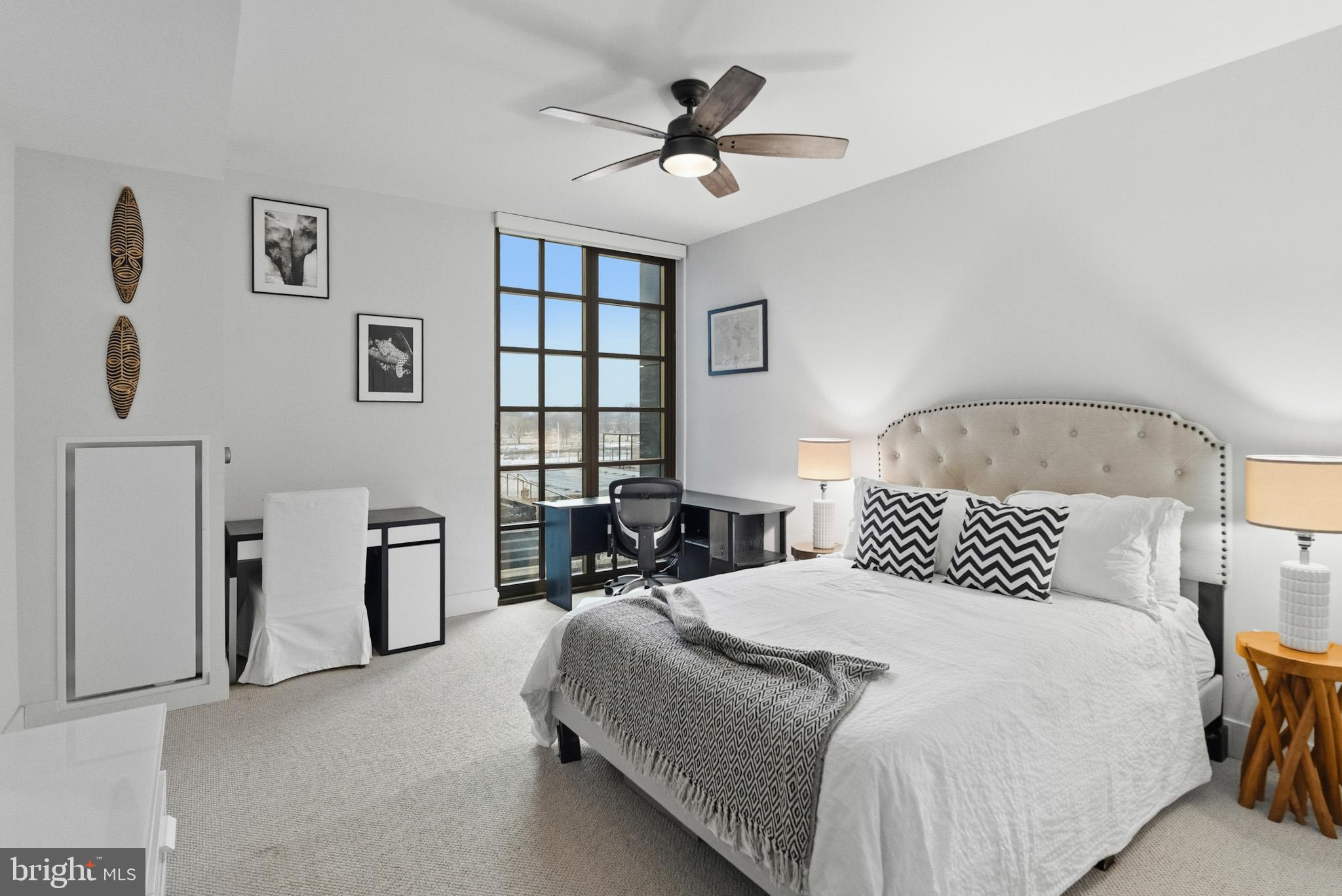 45 Sutton Square Southwest, Unit 403 Washington, DC 20024 - Photo 29 of 80 a bedroom with double bed and a chandelier