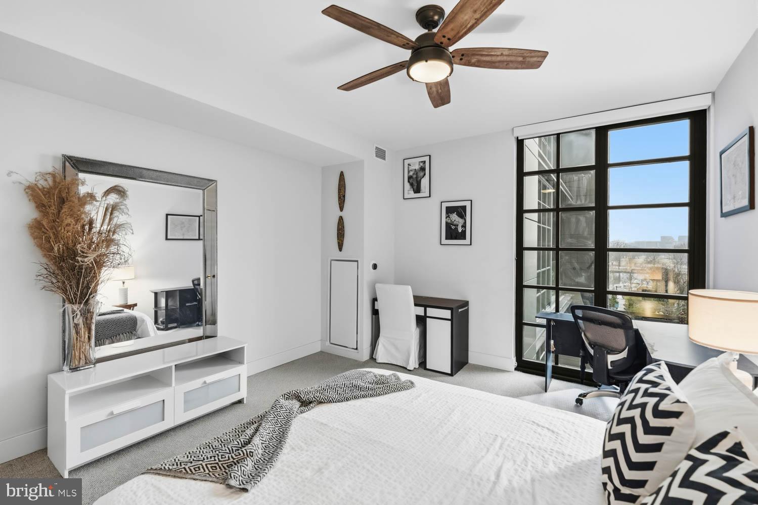 45 Sutton Square Southwest, Unit 403 Washington, DC 20024 - Photo 30 of 80 a bedroom with a bed furniture and a window