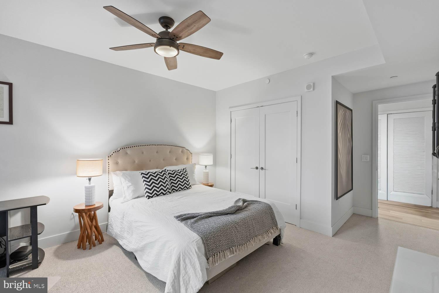 45 Sutton Square Southwest, Unit 403 Washington, DC 20024 - Photo 32 of 80 a bedroom with a bed and a chandelier