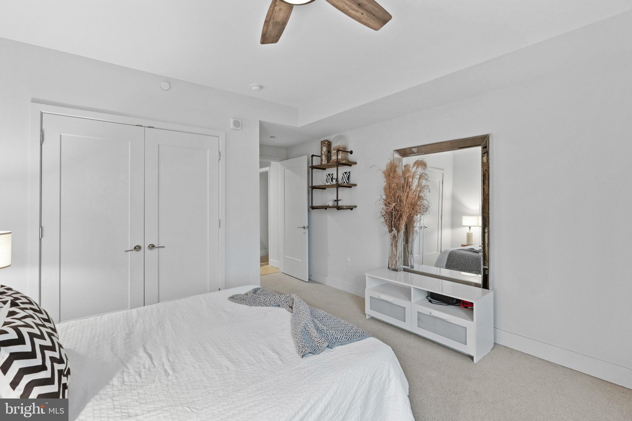 45 Sutton Square Southwest, Unit 403 Washington, DC 20024 - Photo 35 of 80 a bedroom with a bed and a chandelier