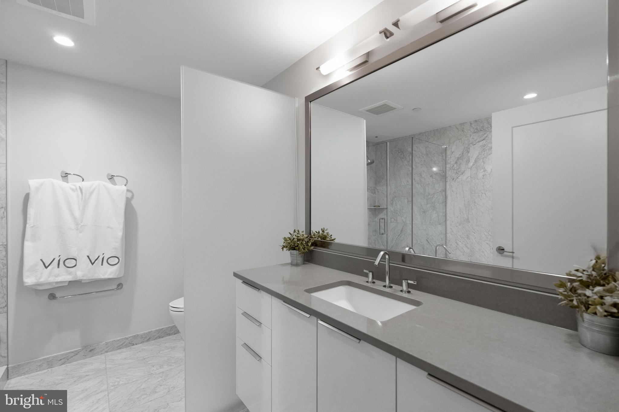 45 Sutton Square Southwest, Unit 403 Washington, DC 20024 - Photo 43 of 80 a bathroom with a sink and a mirror