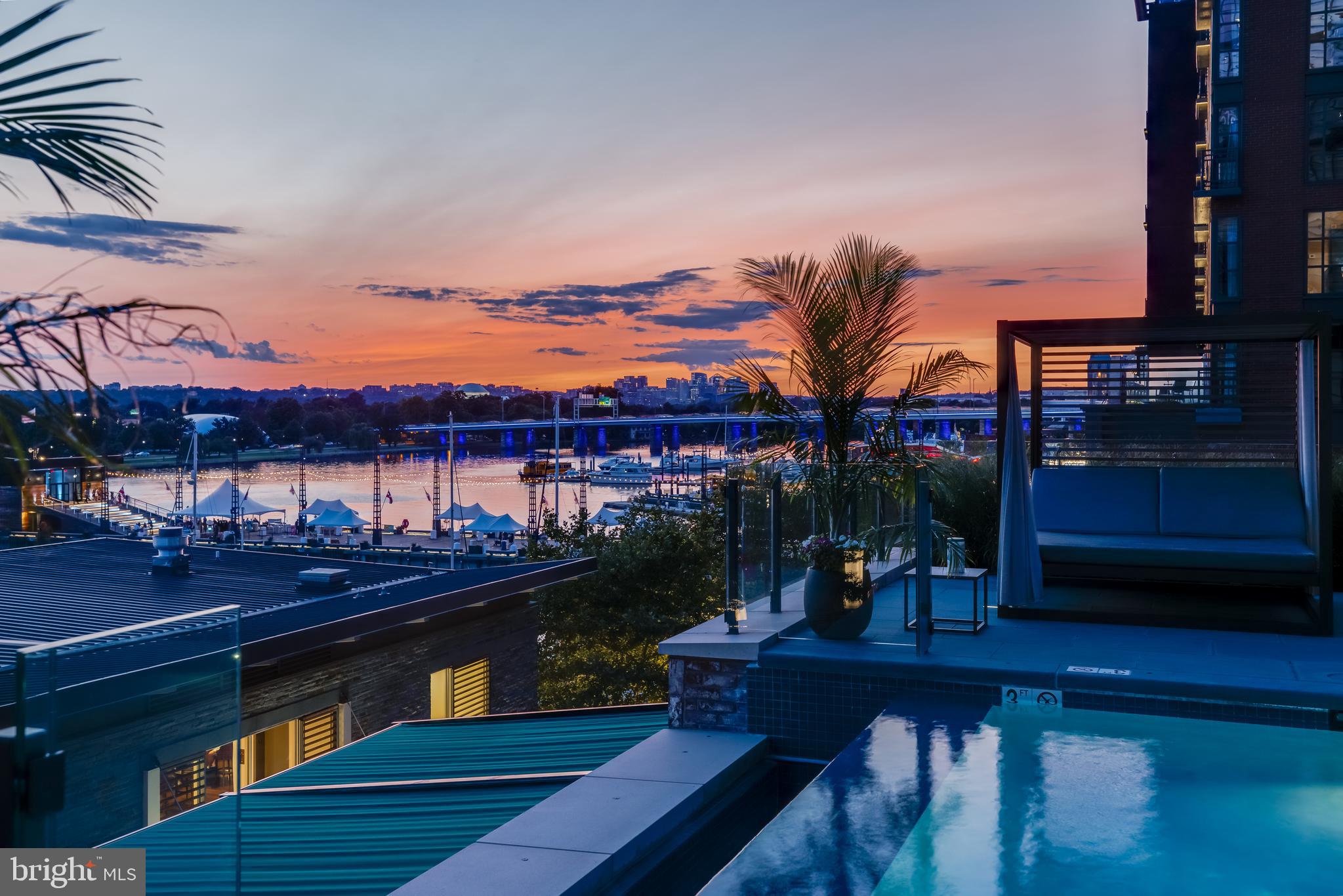 45 Sutton Square Southwest, Unit 403 Washington, DC 20024 - Photo 69 of 80 a view of a lake with a table and chairs