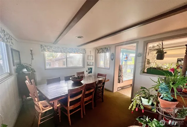 a dining room with furniture and wooden floor
