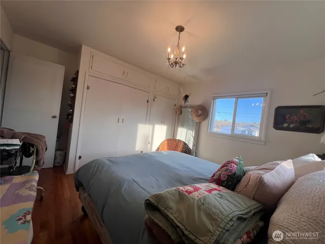 a living room with a bed furniture and a flat screen tv