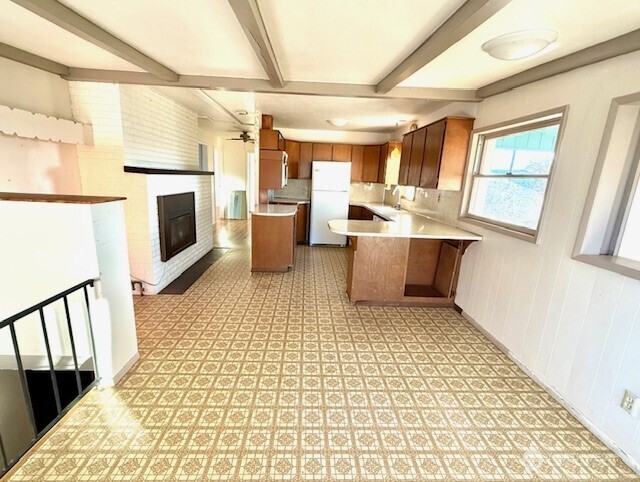 1006 East Dobson Road Odessa, WA 99159 - Photo 15 of 38 a large white kitchen with a stove a sink dishwasher and a fireplace