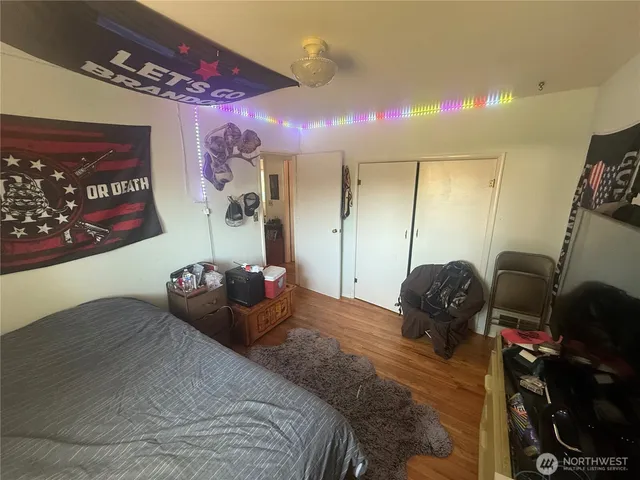 a bed room with a bed and a large mirror