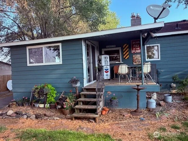 a view of a chairs and table in backyard of the house