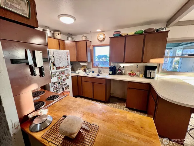 a kitchen with a sink appliances and cabinets