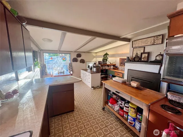 a kitchen with stainless steel appliances a stove a sink and a refrigerator