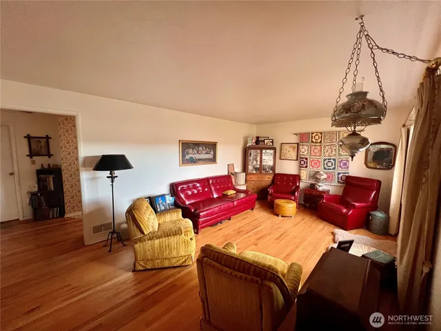 a bedroom with furniture and a wooden floor