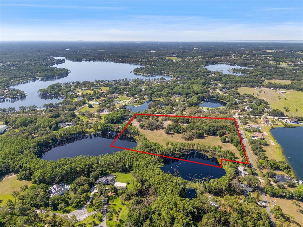 18509 Jiretz Road Odessa, FL 33556 - Photo 1 of 1 an aerial view of residential building and lake