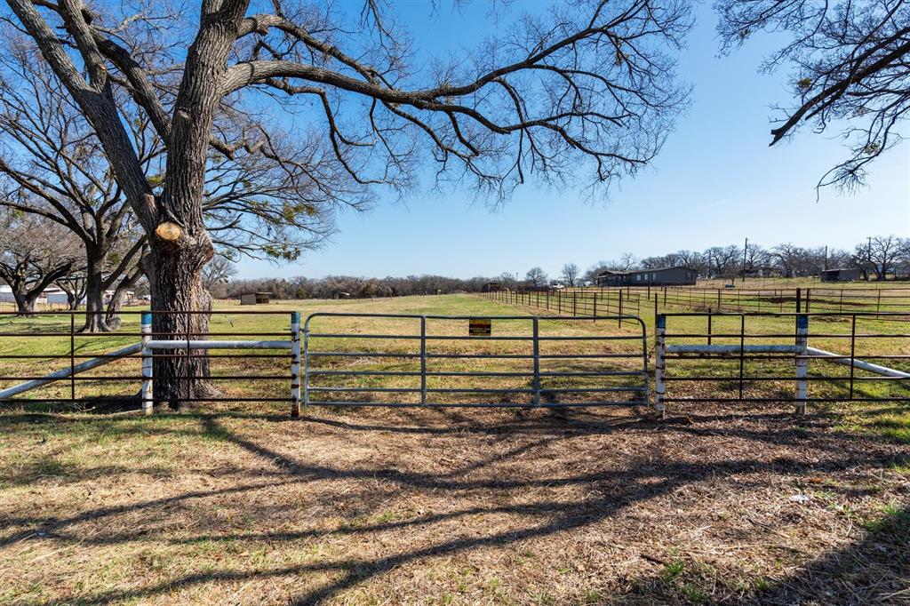 700 Gilliland Road Springtown, TX 76082 - Photo 10 of 12 a view of a yard with wooden fence