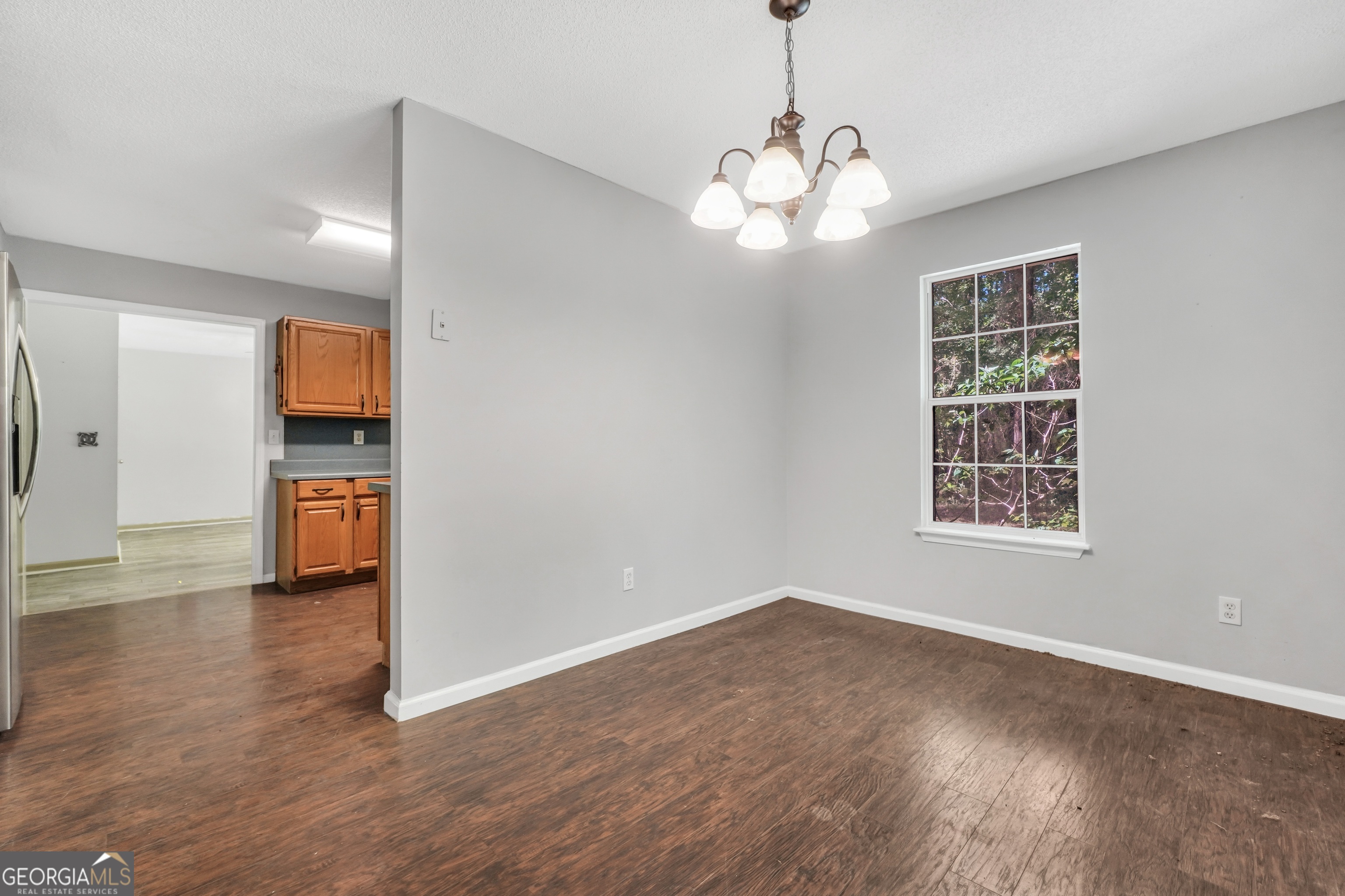 715 Concord Road Shady Dale, GA 31085 - Photo 11 of 38 a view of empty room with wooden floor and window