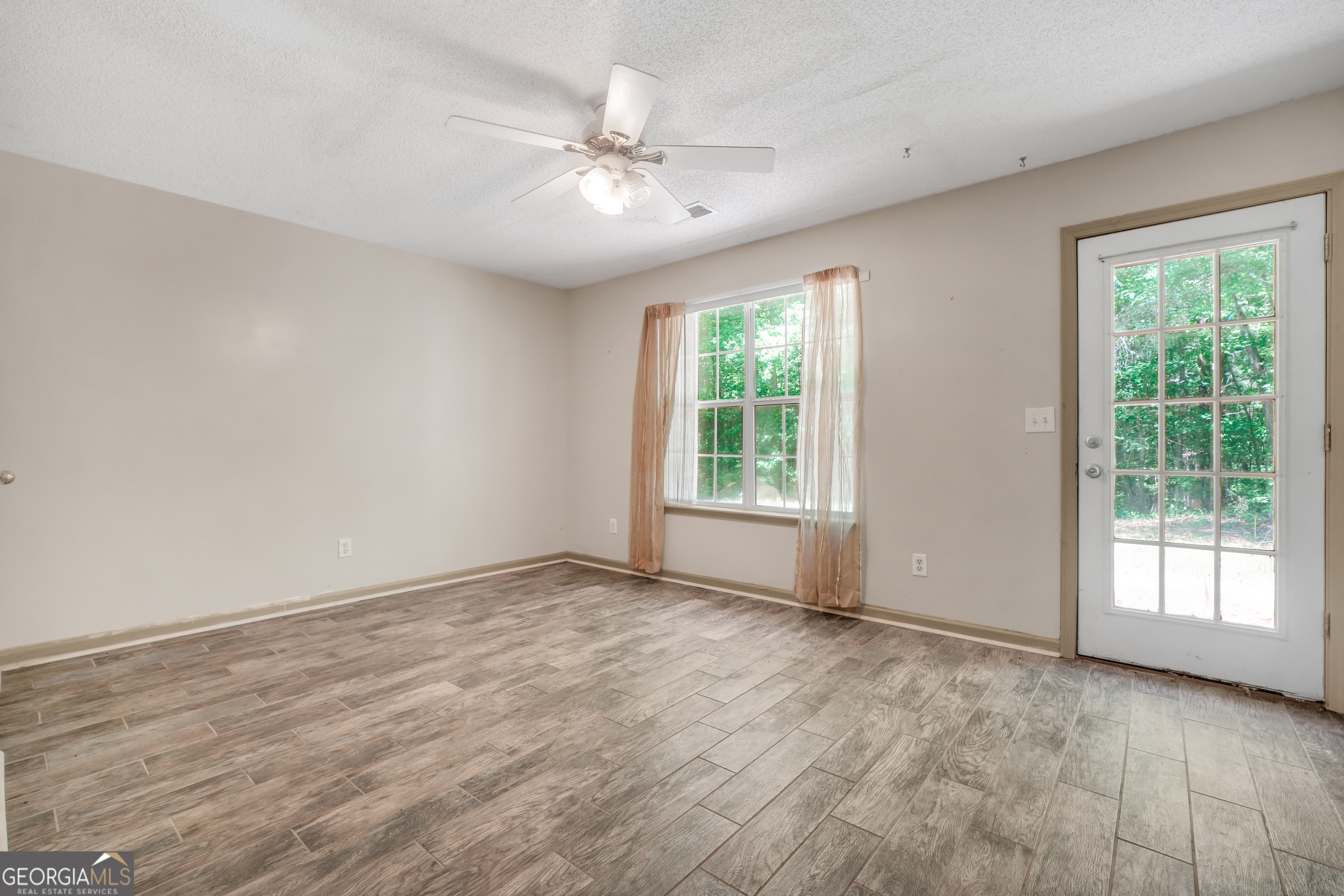 715 Concord Road Shady Dale, GA 31085 - Photo 13 of 38 a view of an empty room with a window