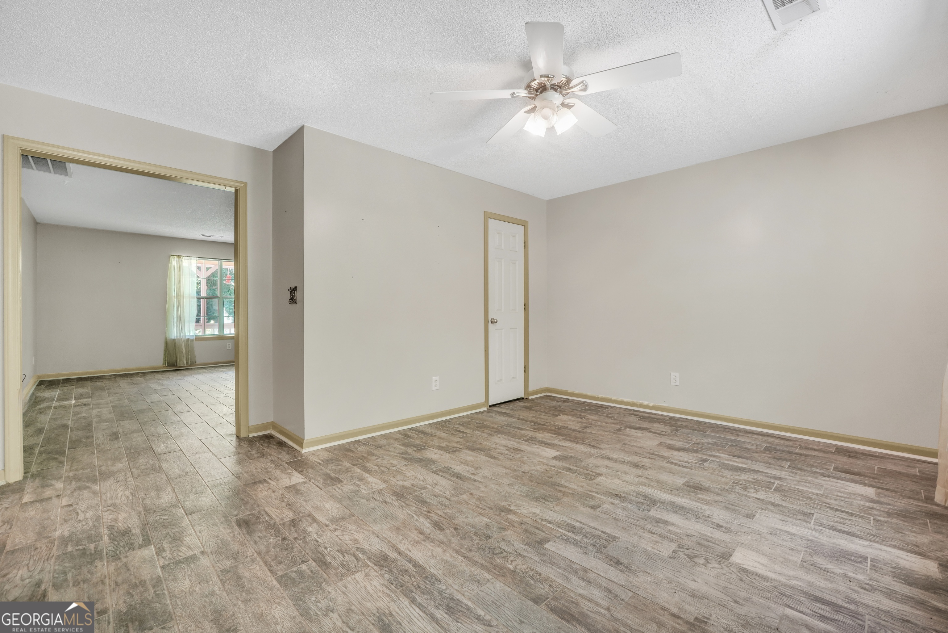 715 Concord Road Shady Dale, GA 31085 - Photo 15 of 38 a view of an empty room with a chandelier fan