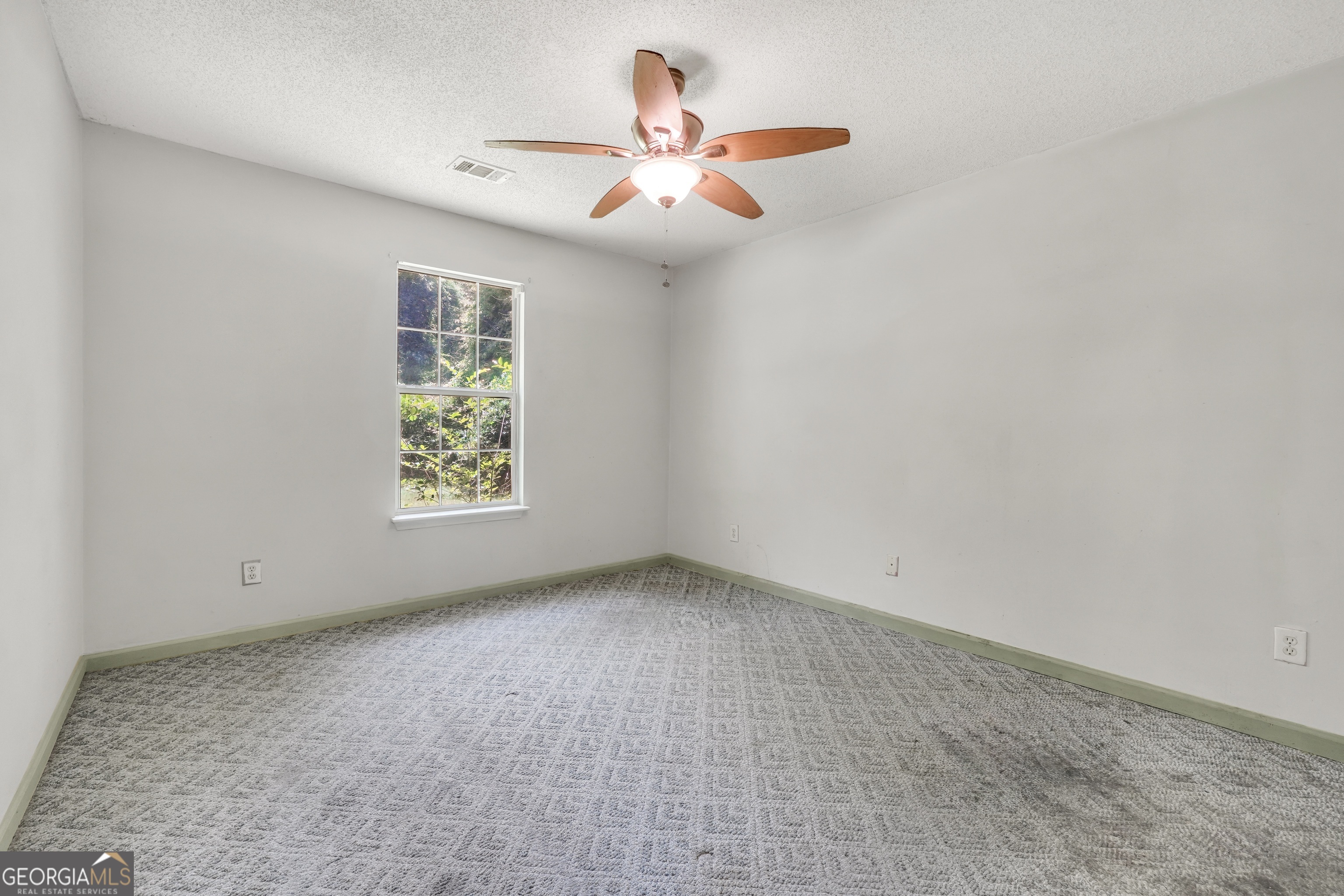 715 Concord Road Shady Dale, GA 31085 - Photo 21 of 38 an empty room with a window