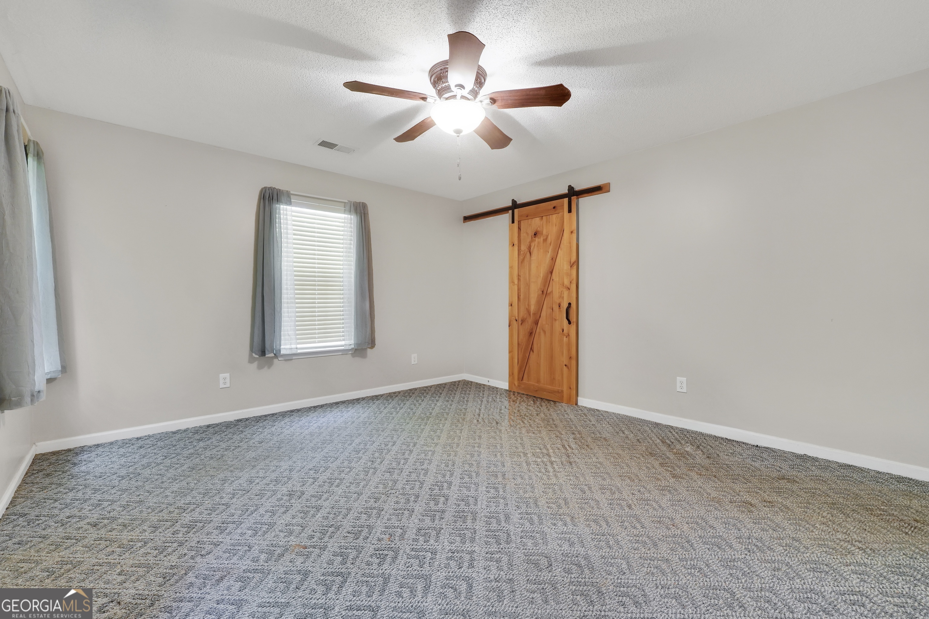 715 Concord Road Shady Dale, GA 31085 - Photo 23 of 38 an empty room with fan and windows
