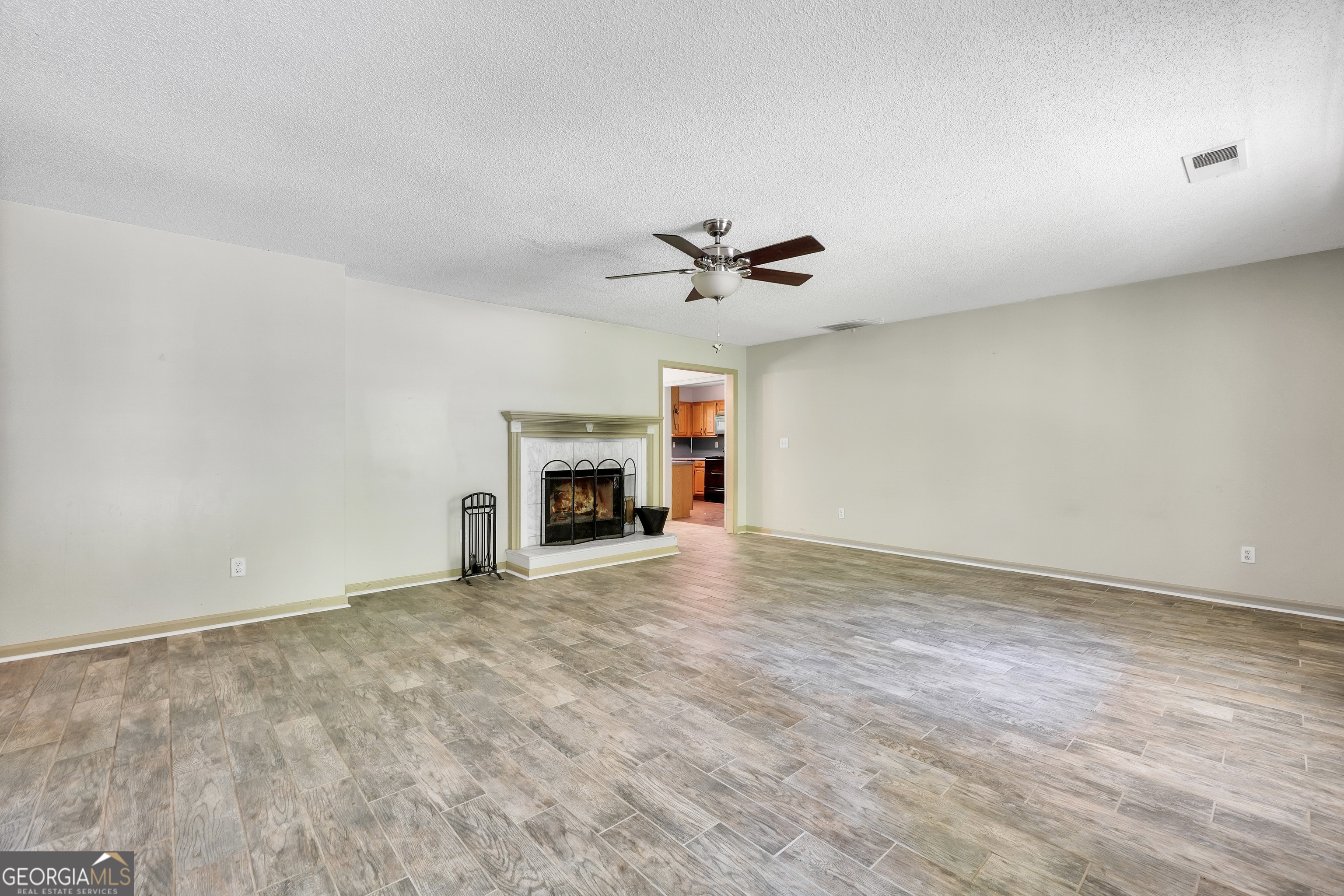 715 Concord Road Shady Dale, GA 31085 - Photo 3 of 38 a view of empty room with a fireplace