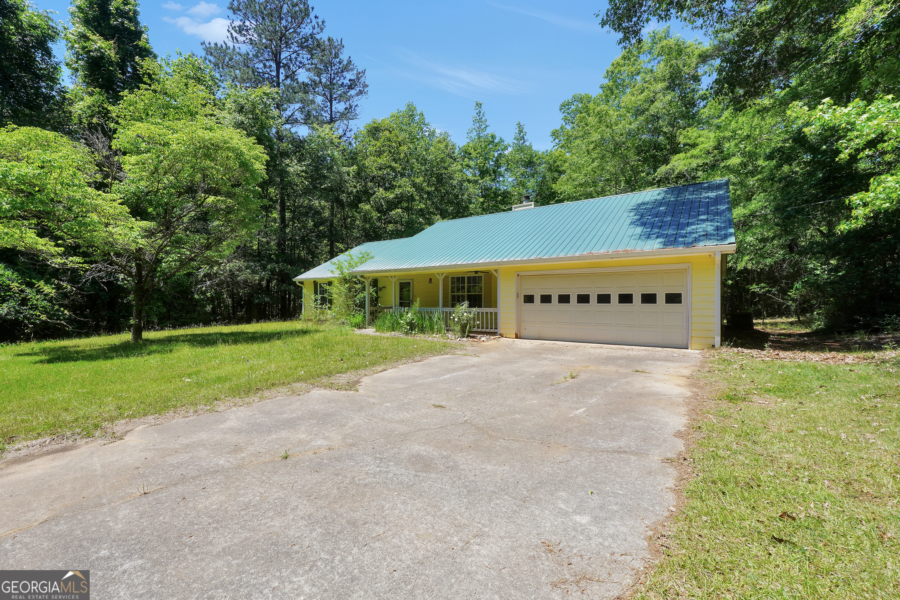 715 Concord Road Shady Dale, GA 31085 - Photo 36 of 38 a view of house with outdoor space and garden