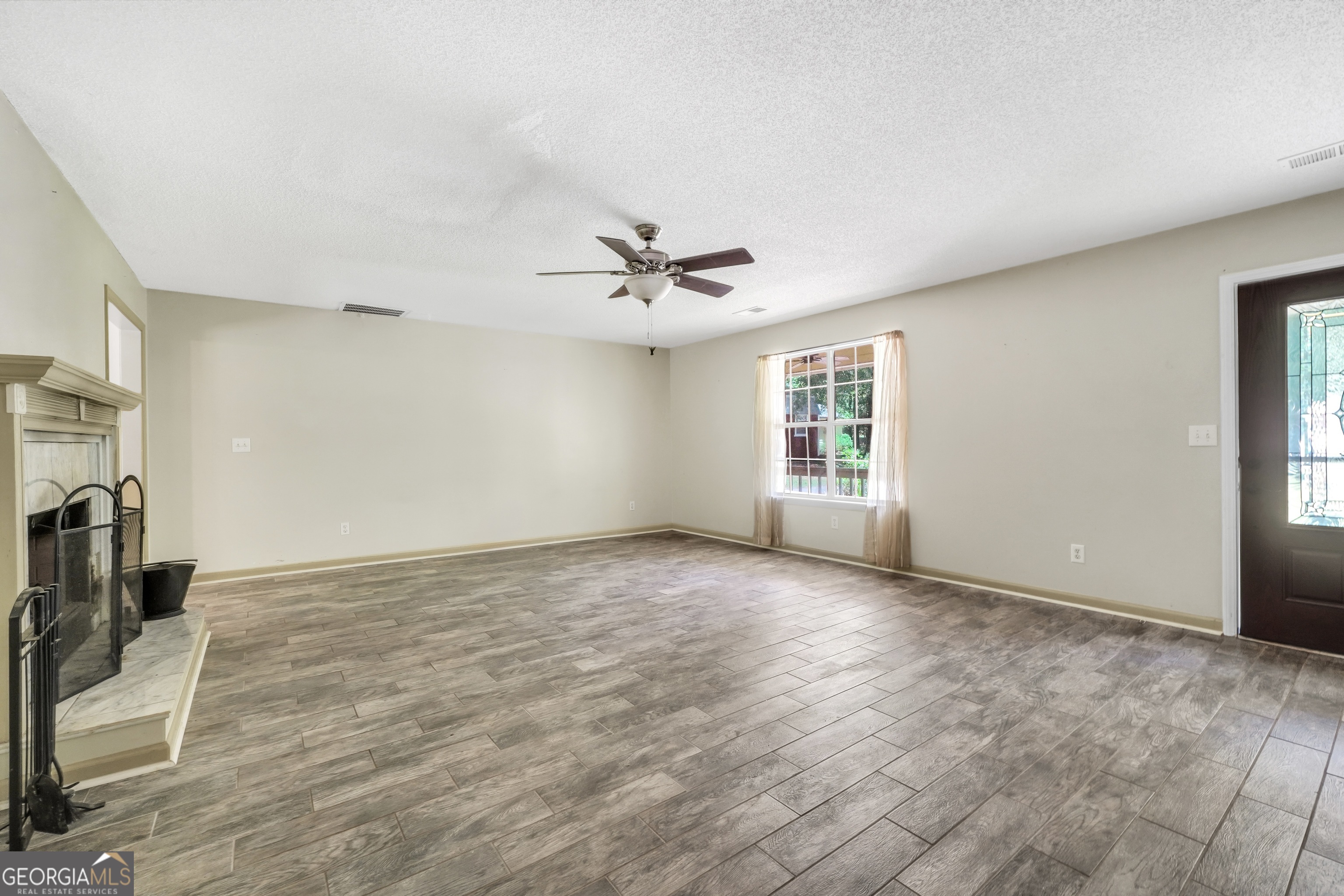715 Concord Road Shady Dale, GA 31085 - Photo 5 of 38 a view of a livingroom with a ceiling fan and window