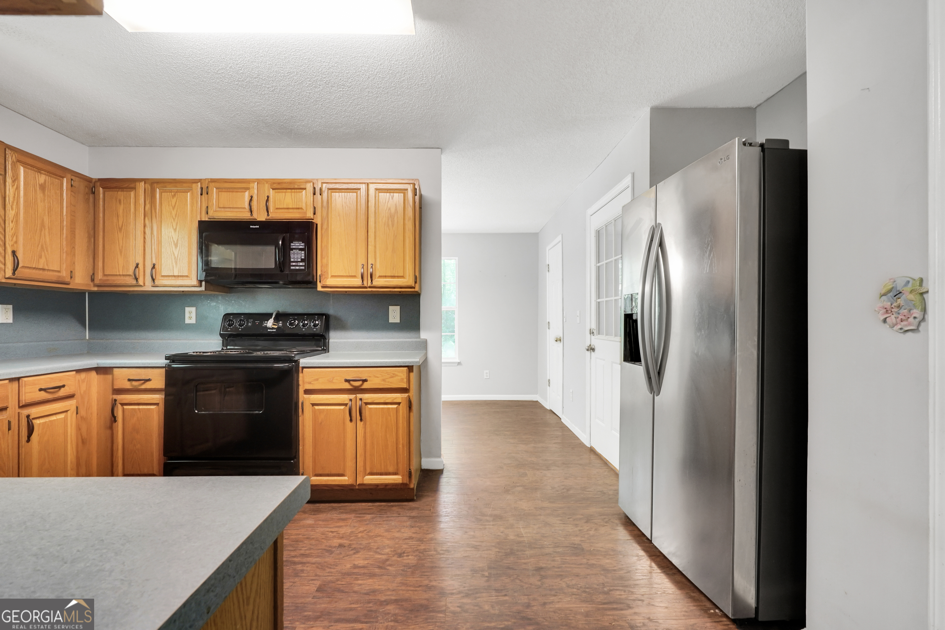 715 Concord Road Shady Dale, GA 31085 - Photo 8 of 38 a kitchen with stainless steel appliances granite countertop a refrigerator stove top oven a sink and dishwasher