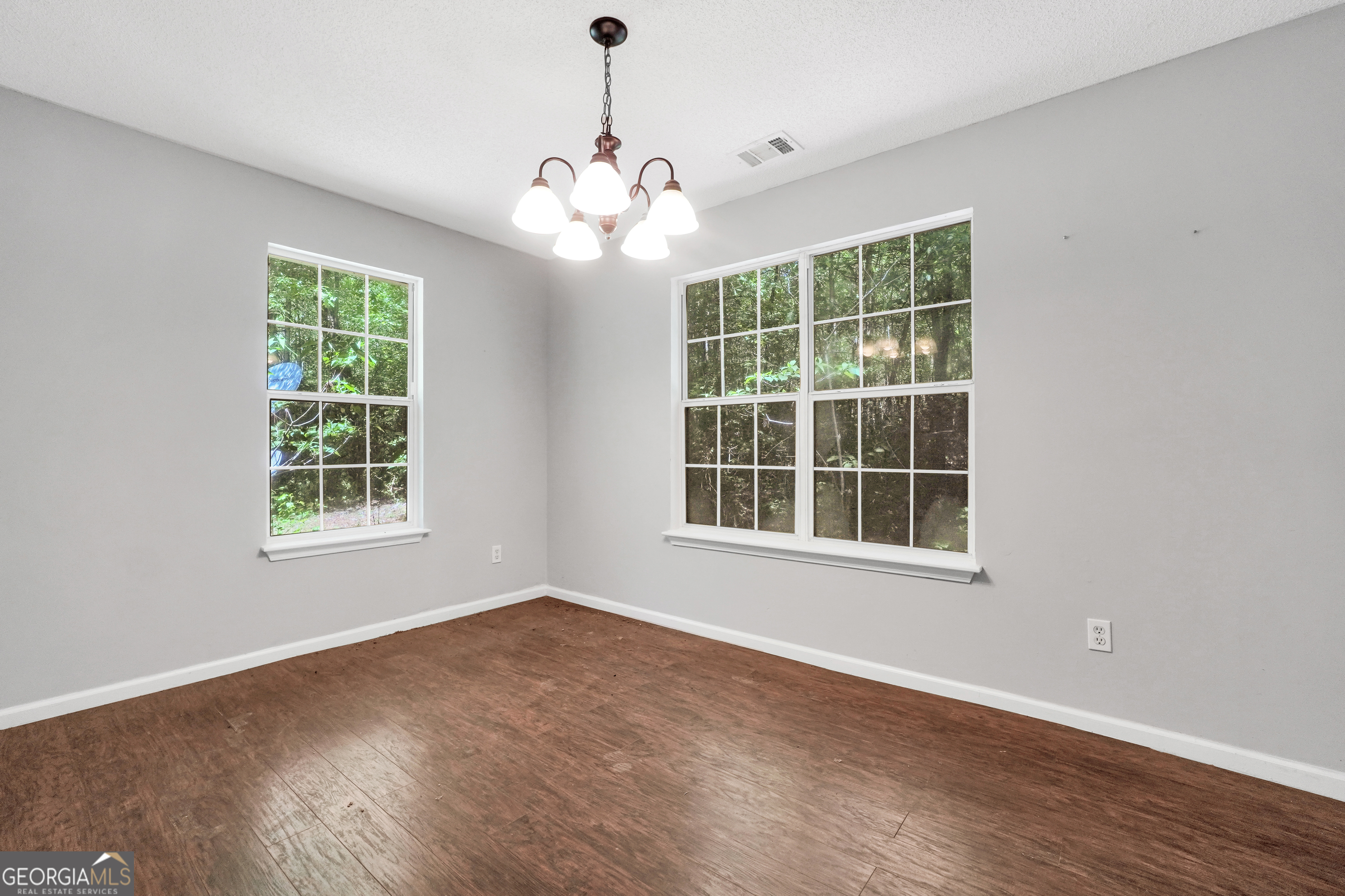 715 Concord Road Shady Dale, GA 31085 - Photo 10 of 38 a view of an empty room with wooden floor and a window