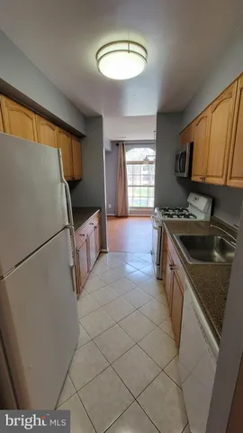 a kitchen with stainless steel appliances a refrigerator sink and cabinets