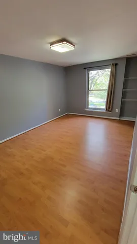 a room with a chair and wooden floor