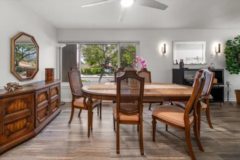 a view of a dining room with furniture window and wooden floor