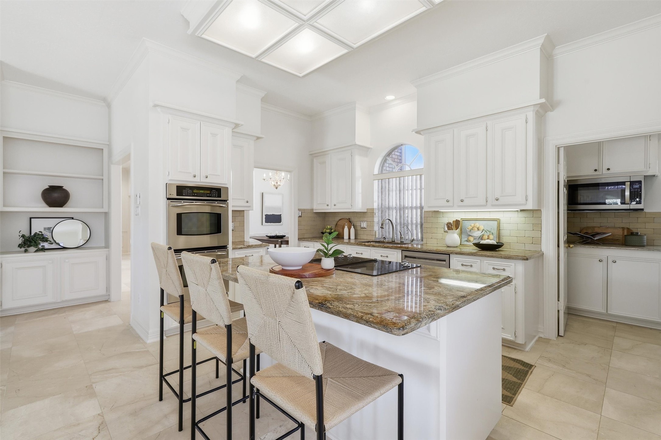 1918 Winter Knoll Way Houston, TX 77062 - Photo 12 of 46 Kitchen island with seating and cooktop, ideal for gatherings and everyday meals.