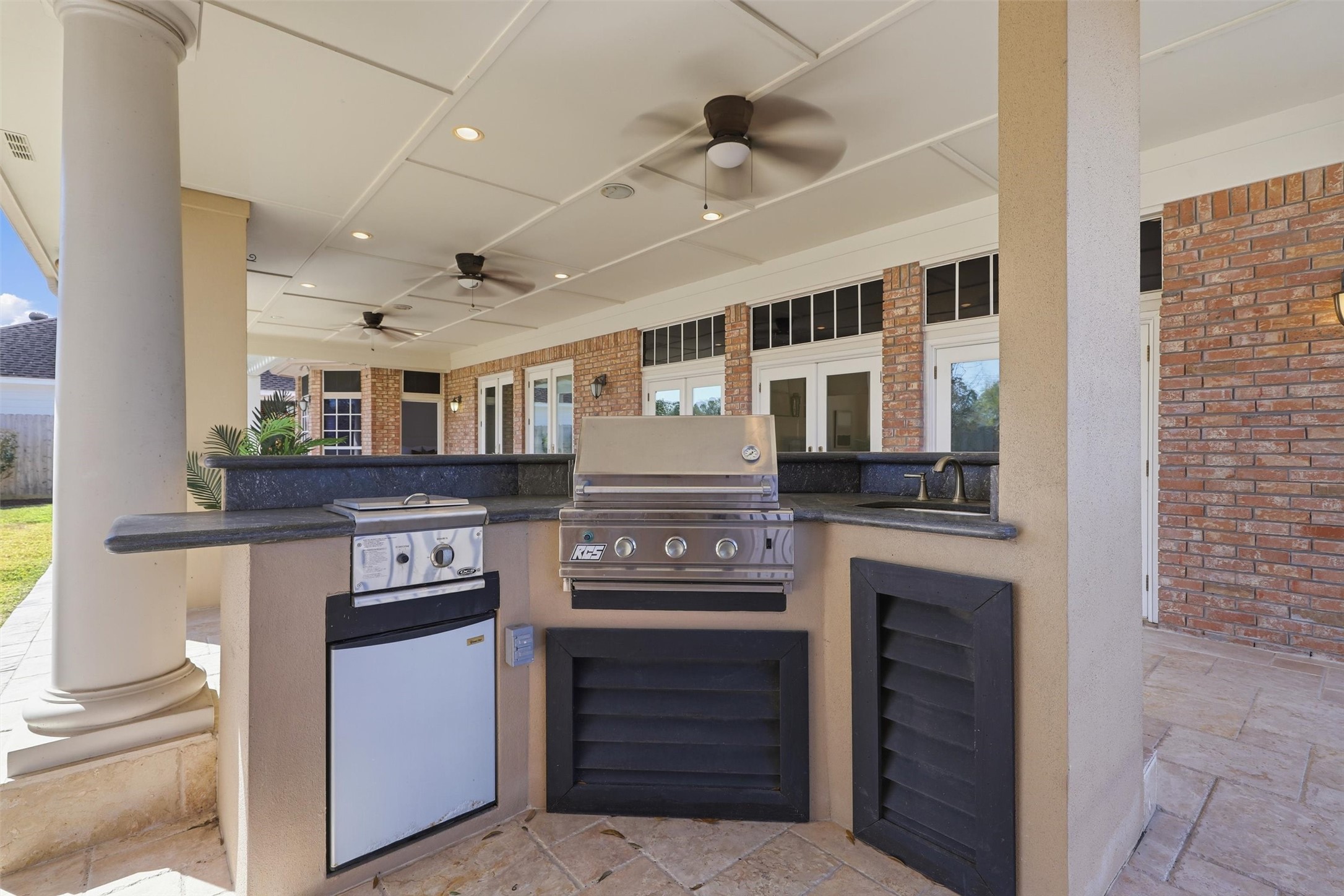 1918 Winter Knoll Way Houston, TX 77062 - Photo 31 of 46 Outdoor kitchen with leathered granite countertops, stainless steel grill, and gas cooktop.