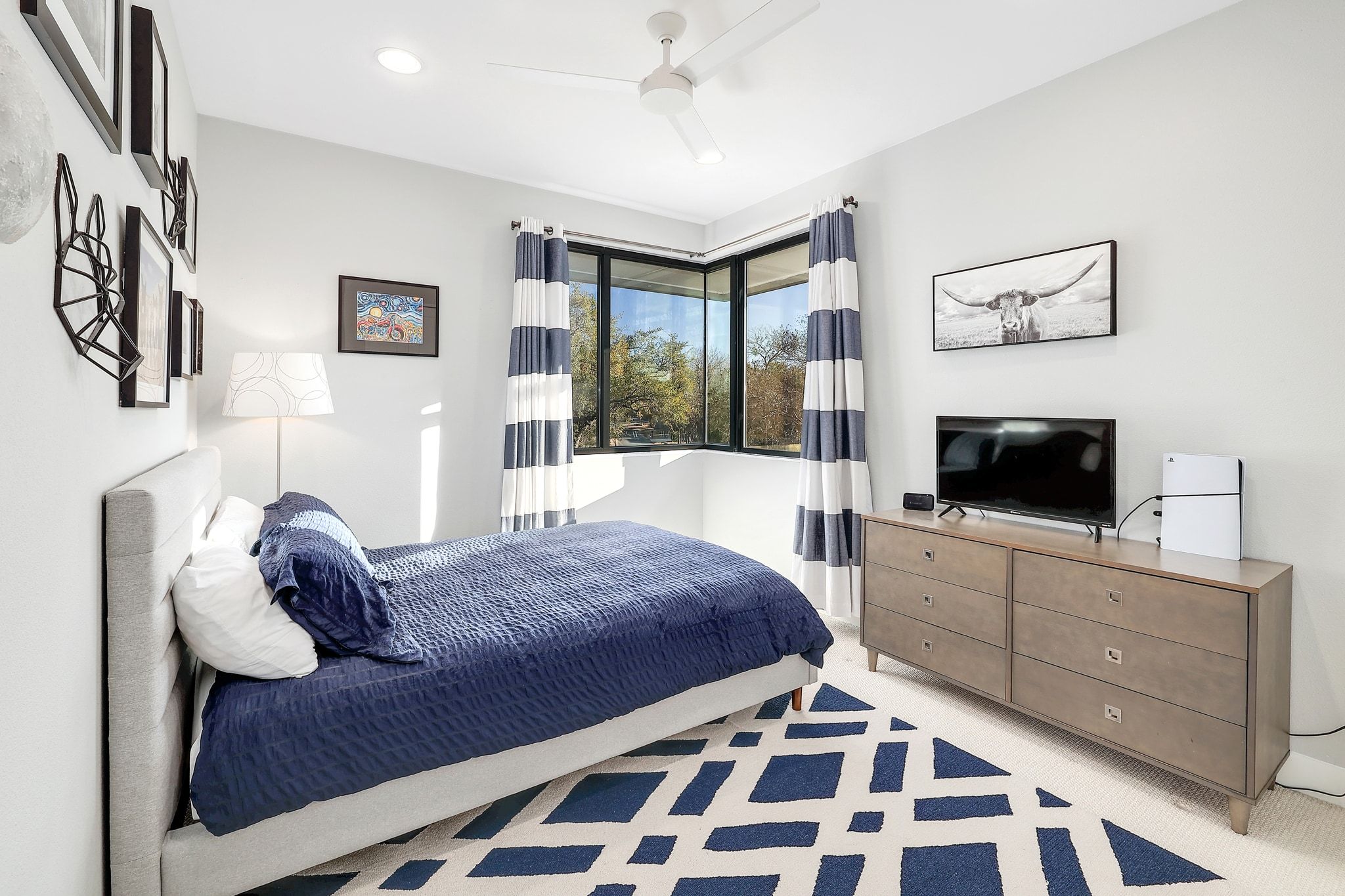 5710 Longhorn Landing Austin, TX 78734 - Photo 16 of 37 a bedroom with a bed and a flat screen tv