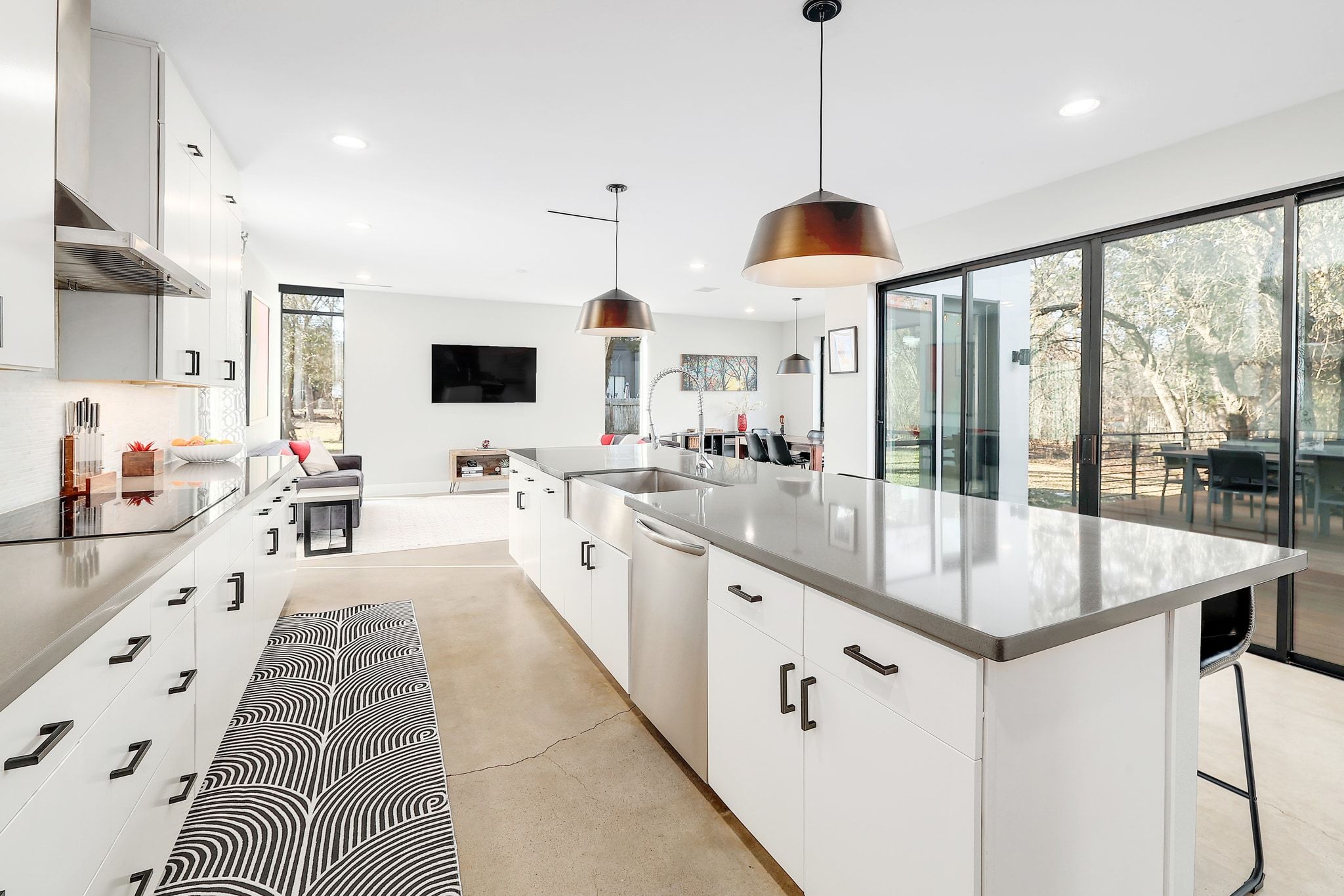 5710 Longhorn Landing Austin, TX 78734 - Photo 6 of 37 a large kitchen with kitchen island a large counter space and stainless steel appliances
