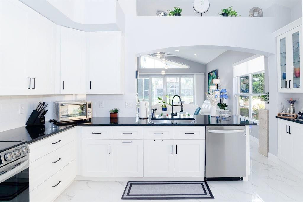 6192 Northwest 24th Street Boca Raton, FL 33434 - Photo 11 of 57 a kitchen with granite countertop white cabinets and white appliances