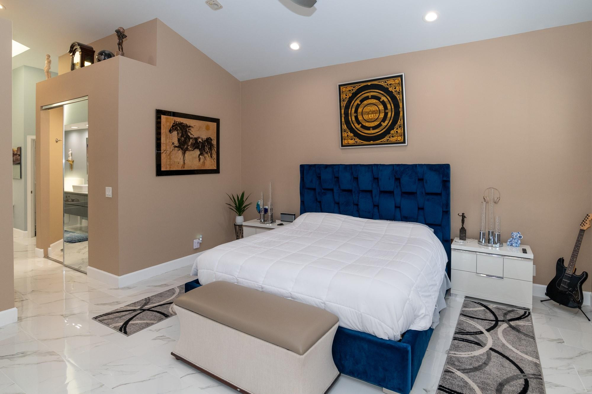 6192 Northwest 24th Street Boca Raton, FL 33434 - Photo 14 of 57 a bedroom with a bed and painting on the wall
