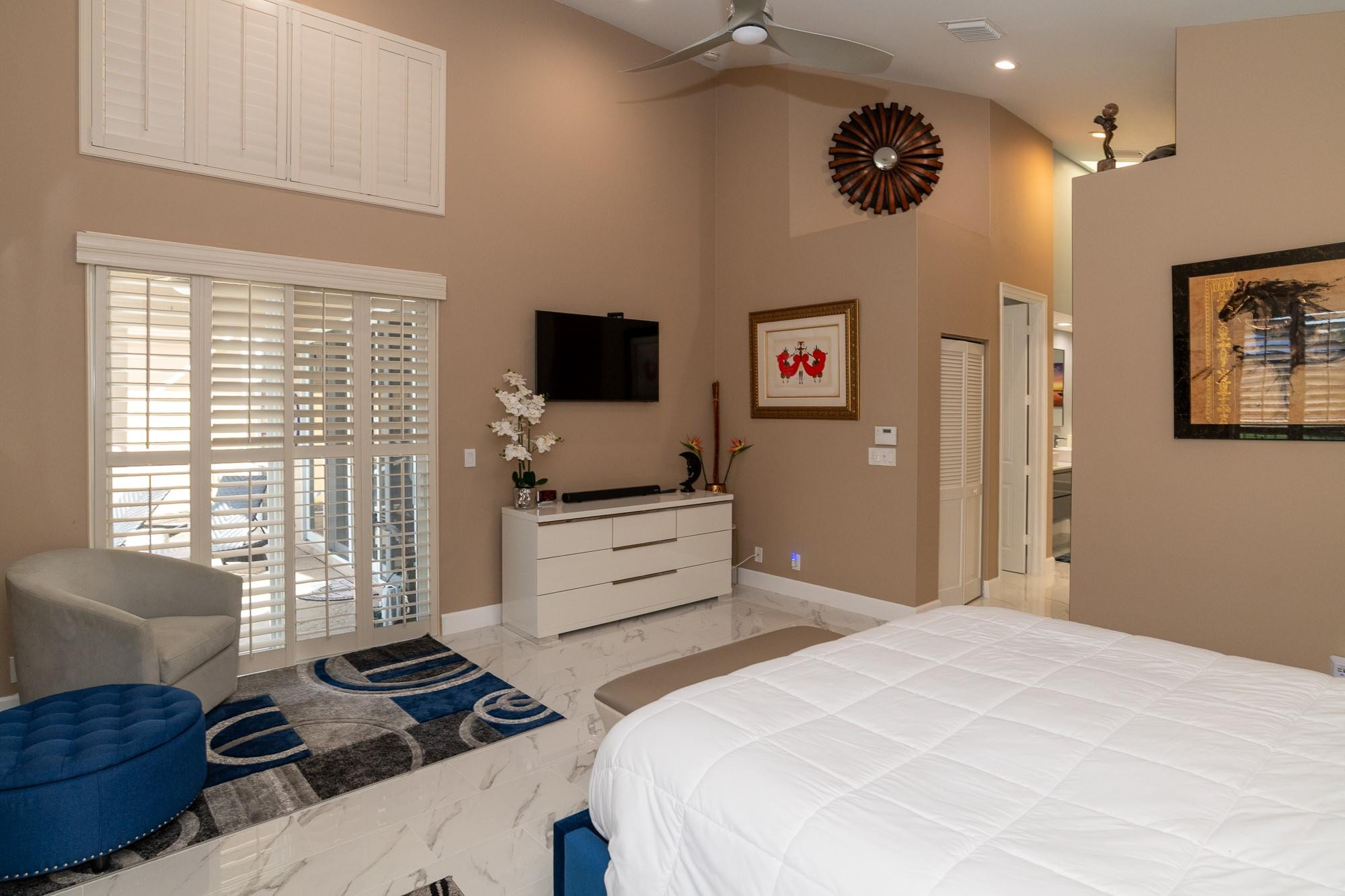 6192 Northwest 24th Street Boca Raton, FL 33434 - Photo 15 of 57 a bedroom with a bed and a television