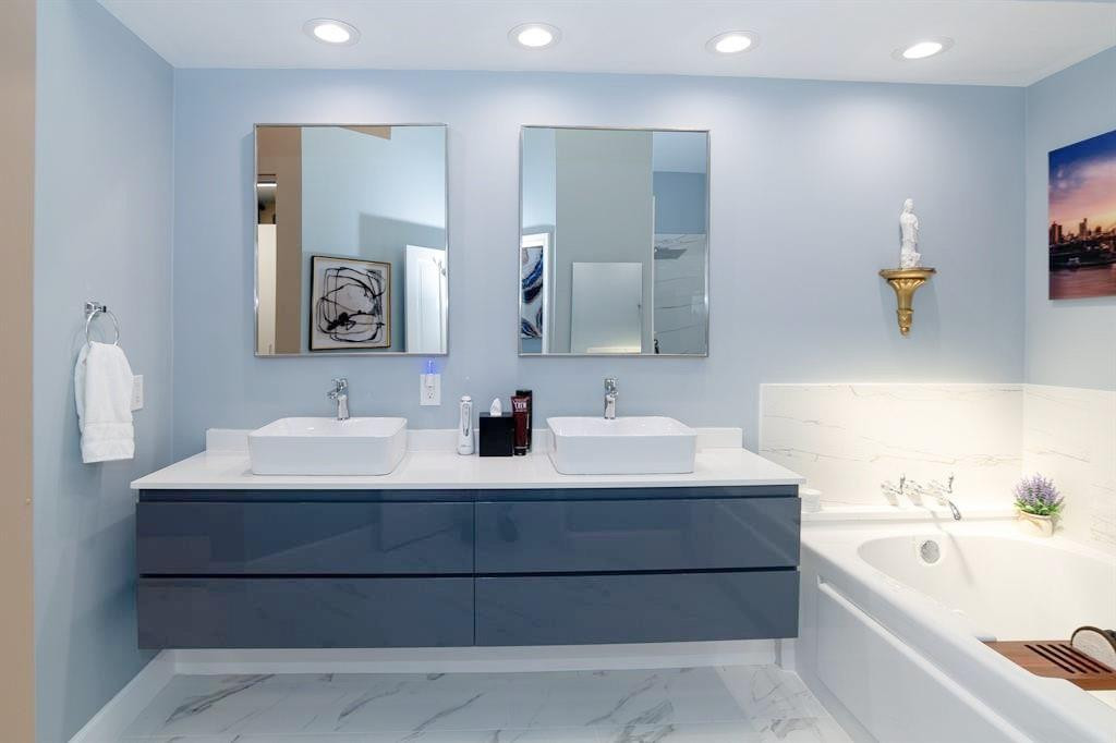 6192 Northwest 24th Street Boca Raton, FL 33434 - Photo 16 of 57 a bathroom with a bathtub sink and mirror
