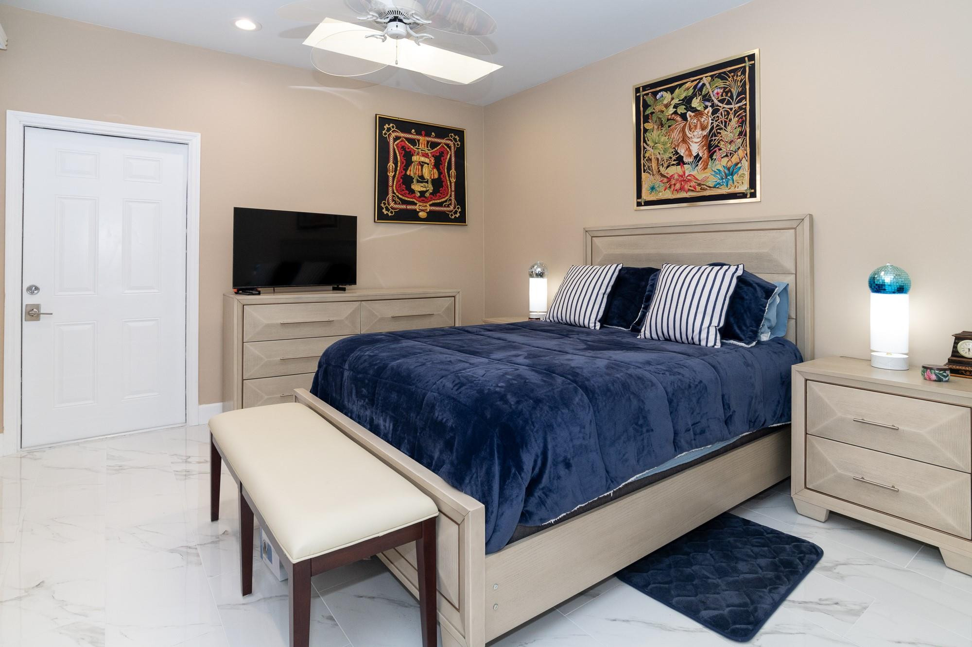 6192 Northwest 24th Street Boca Raton, FL 33434 - Photo 23 of 57 a bedroom with a bed and a flat screen tv