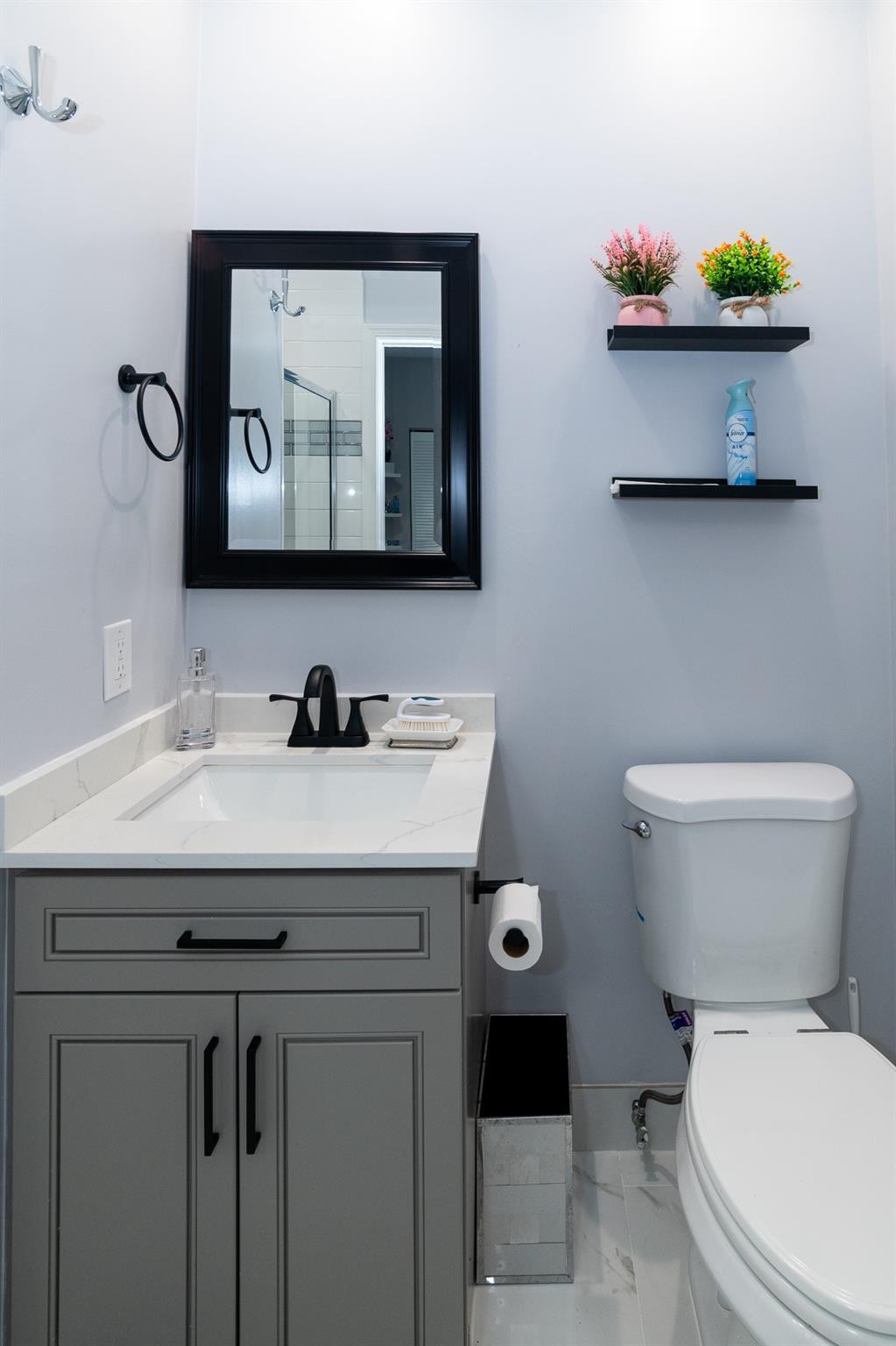 6192 Northwest 24th Street Boca Raton, FL 33434 - Photo 29 of 57 a bathroom with a toilet sink and mirror