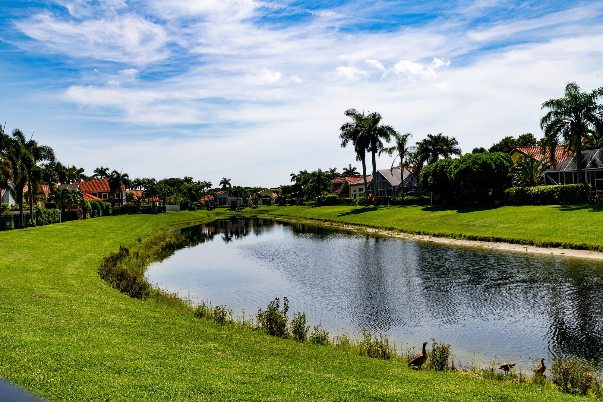 6192 Northwest 24th Street Boca Raton, FL 33434 - Photo 36 of 57 a view of a lake with a yard