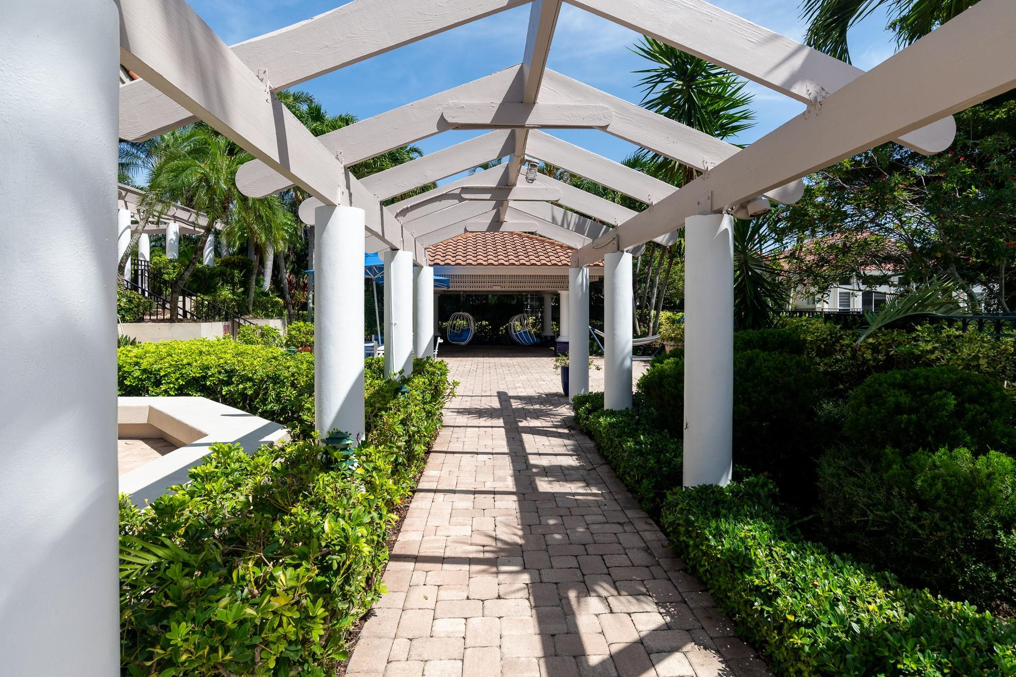 6192 Northwest 24th Street Boca Raton, FL 33434 - Photo 49 of 57 a view of a house with a porch entrance and potted plants