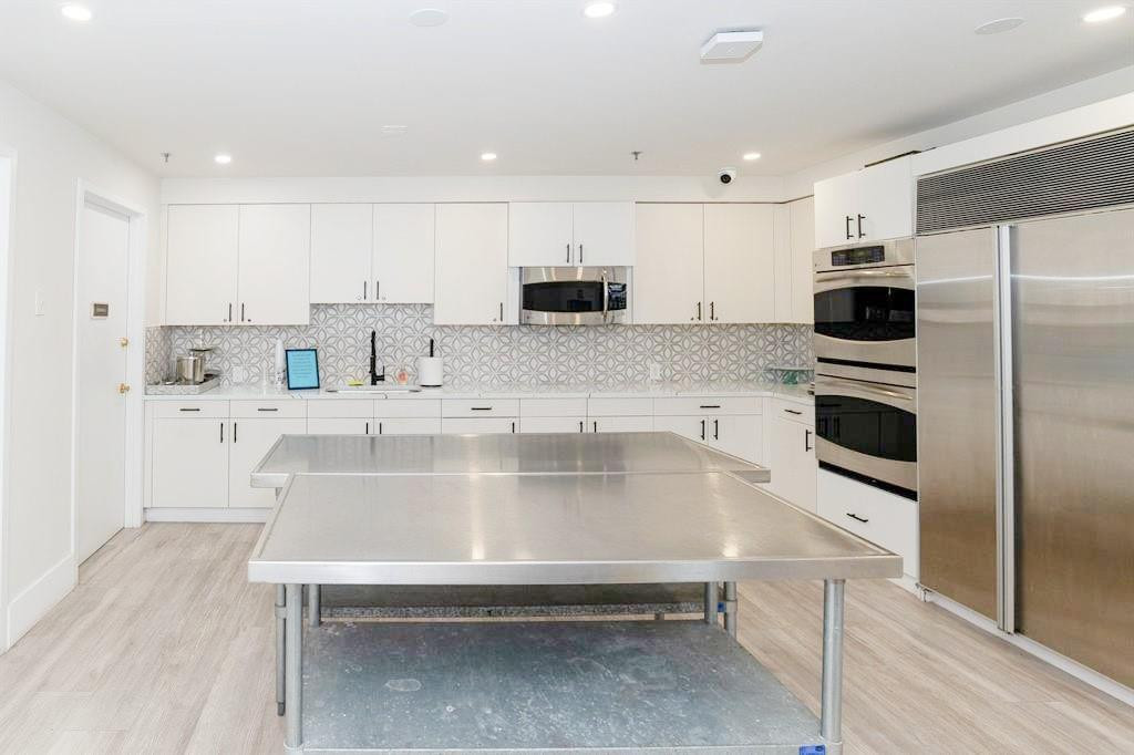 6192 Northwest 24th Street Boca Raton, FL 33434 - Photo 56 of 57 a kitchen with kitchen island a sink stainless steel appliances and cabinets