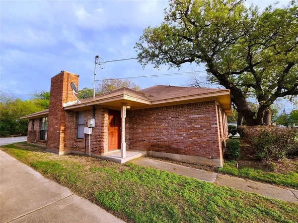 front view of a house with a tree