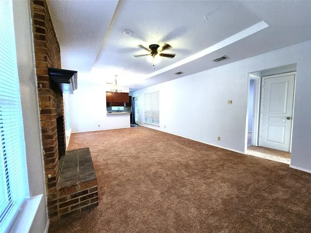 a view of empty room with a fireplace