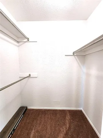 a bathroom with a granite countertop sink toilet a mirror and a bathtub